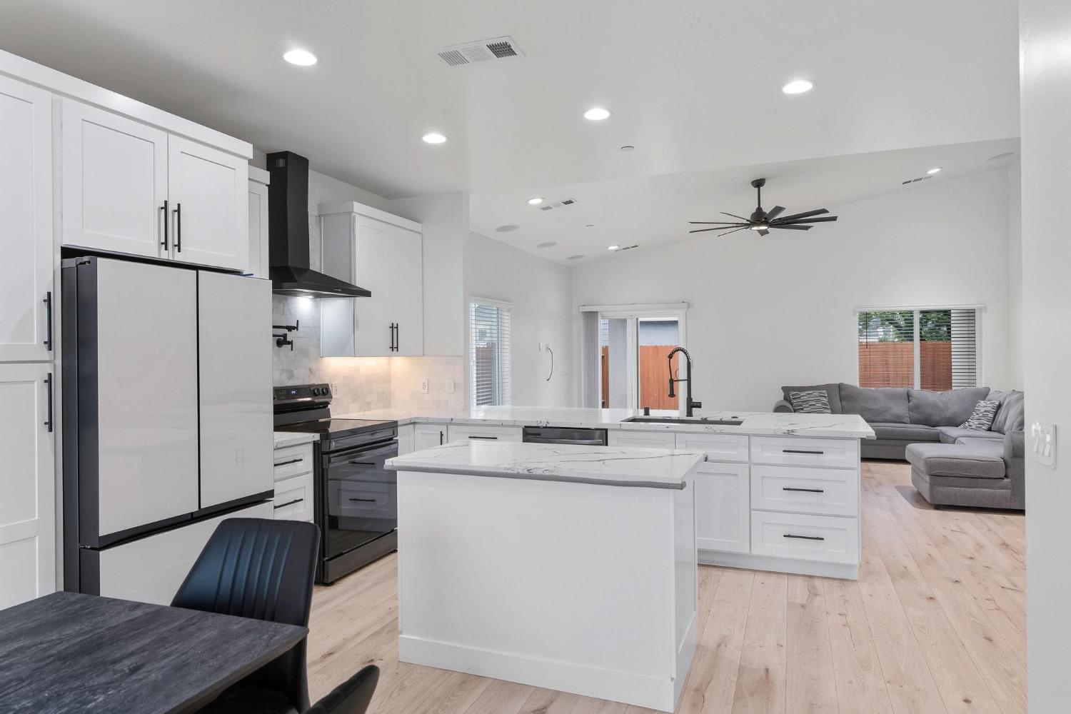 622 North Stockton Avenue Ripon, CA 95366 - Photo 12 of 34 a kitchen with white cabinets and stainless steel appliances