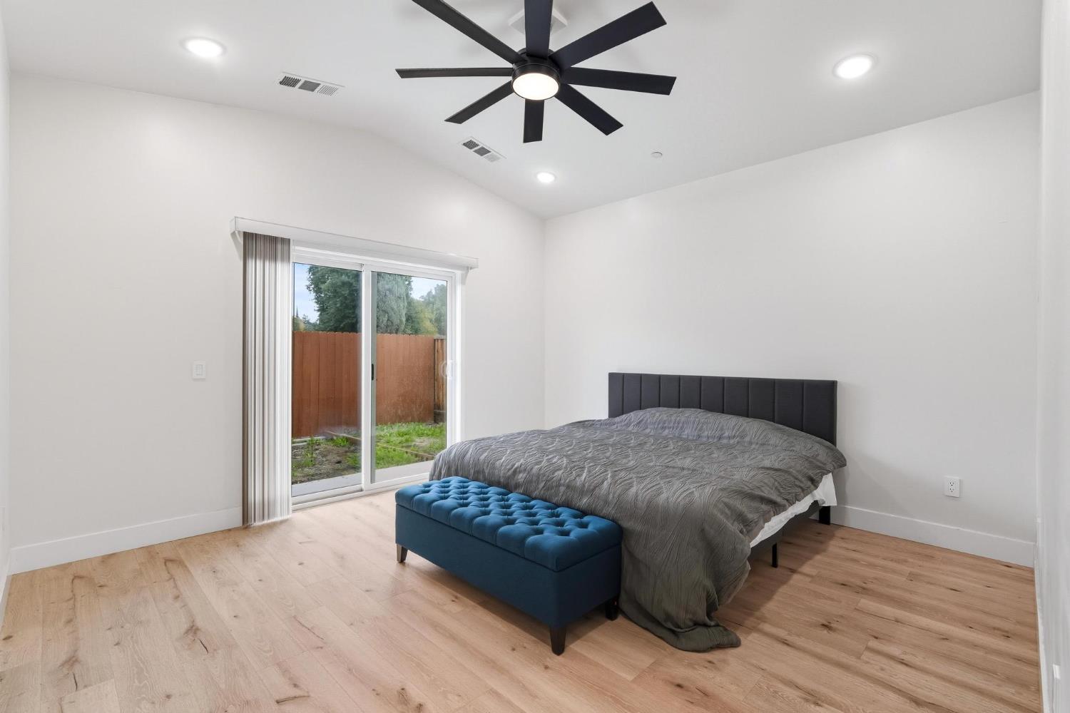 622 North Stockton Avenue Ripon, CA 95366 - Photo 15 of 34 a bedroom with a bed and a chandelier