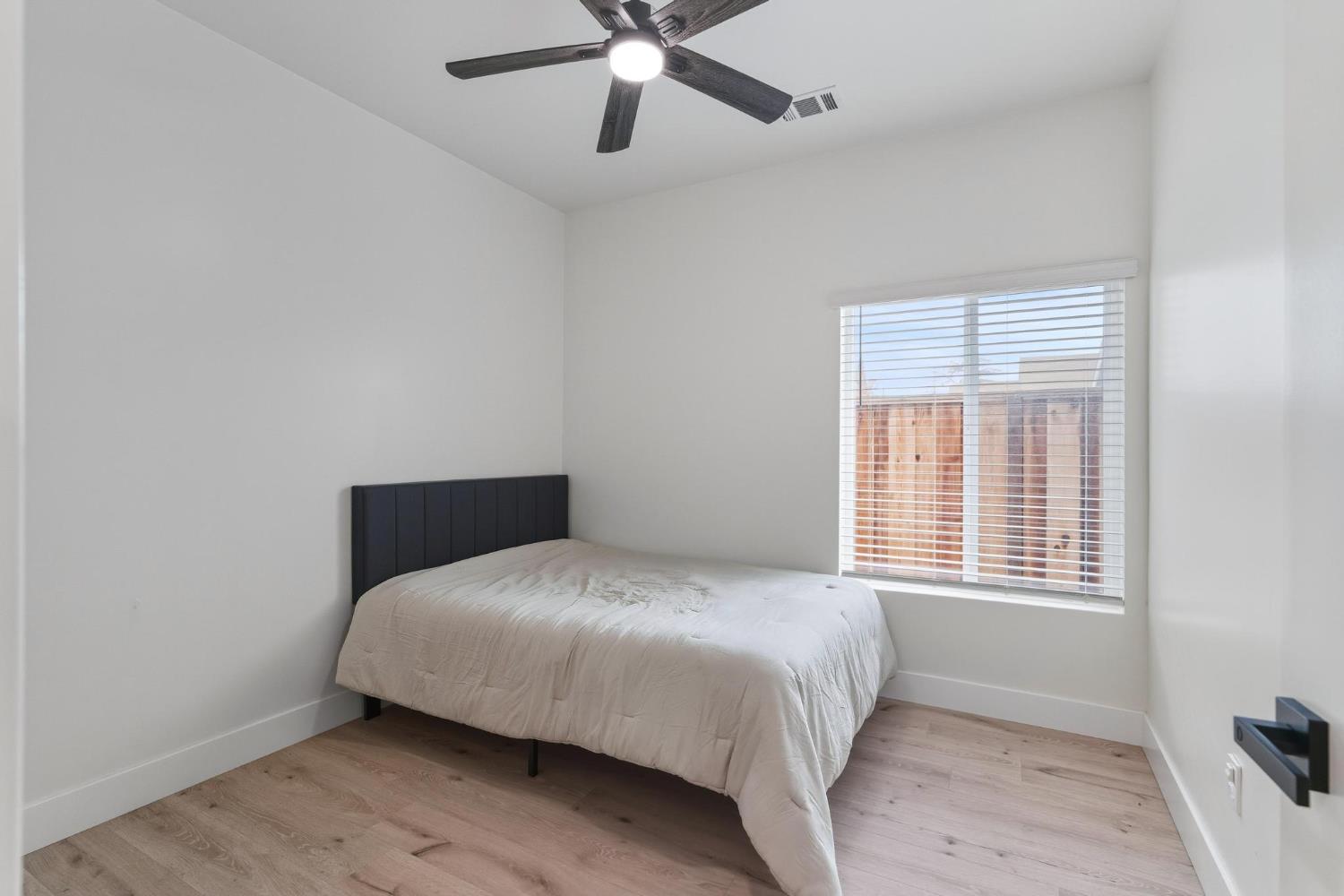 622 North Stockton Avenue Ripon, CA 95366 - Photo 19 of 34 a bedroom with a bed and window