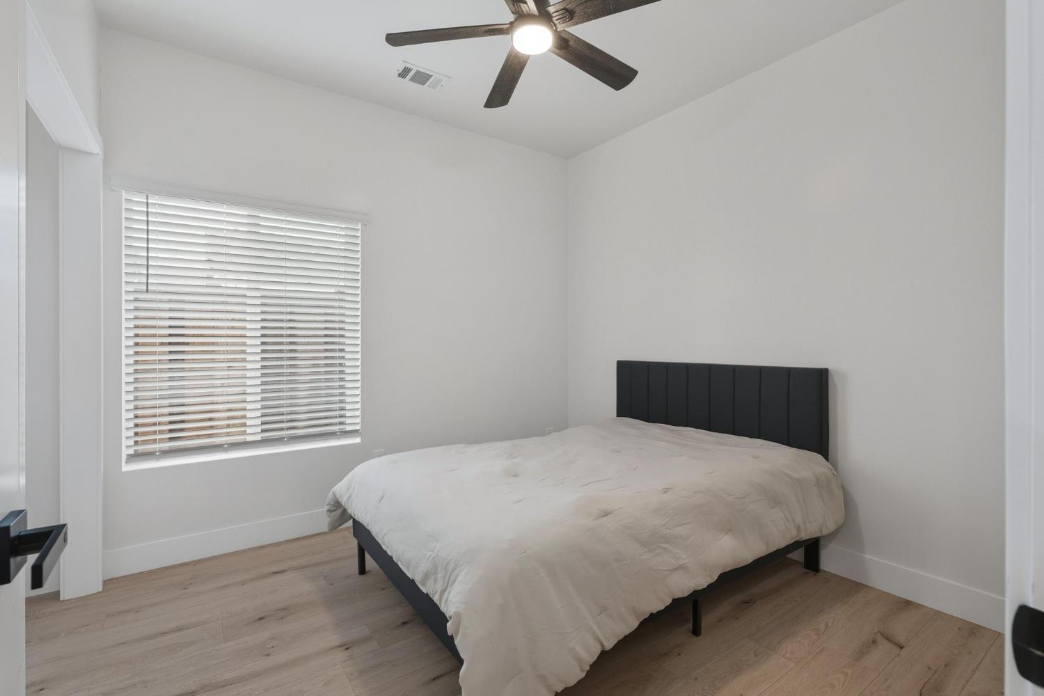 622 North Stockton Avenue Ripon, CA 95366 - Photo 21 of 34 a bedroom with a bed and window