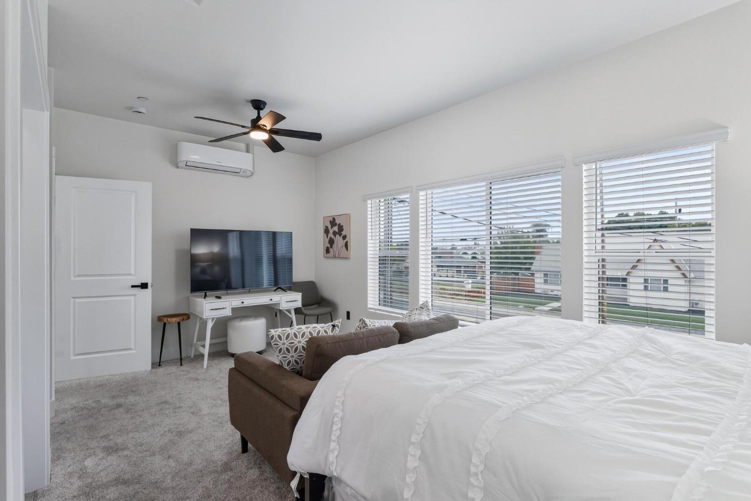 622 North Stockton Avenue Ripon, CA 95366 - Photo 26 of 34 a bed room with a bed a television and a large window