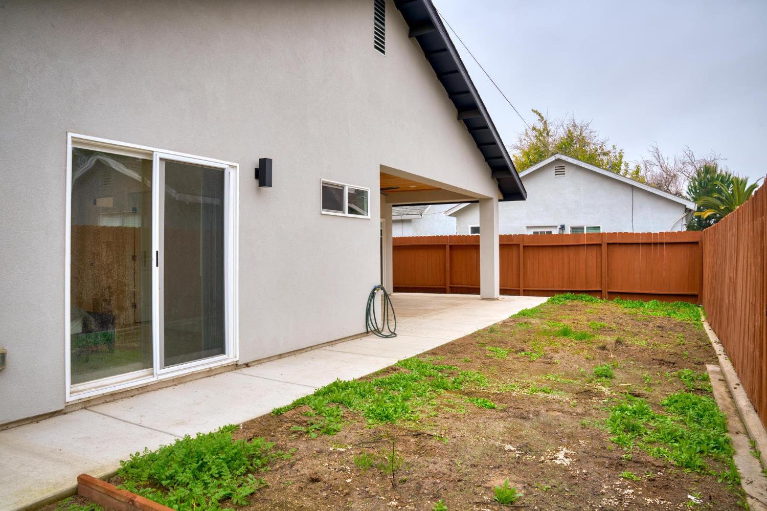 622 North Stockton Avenue Ripon, CA 95366 - Photo 30 of 34 a view of backyard with large tree and wooden fence