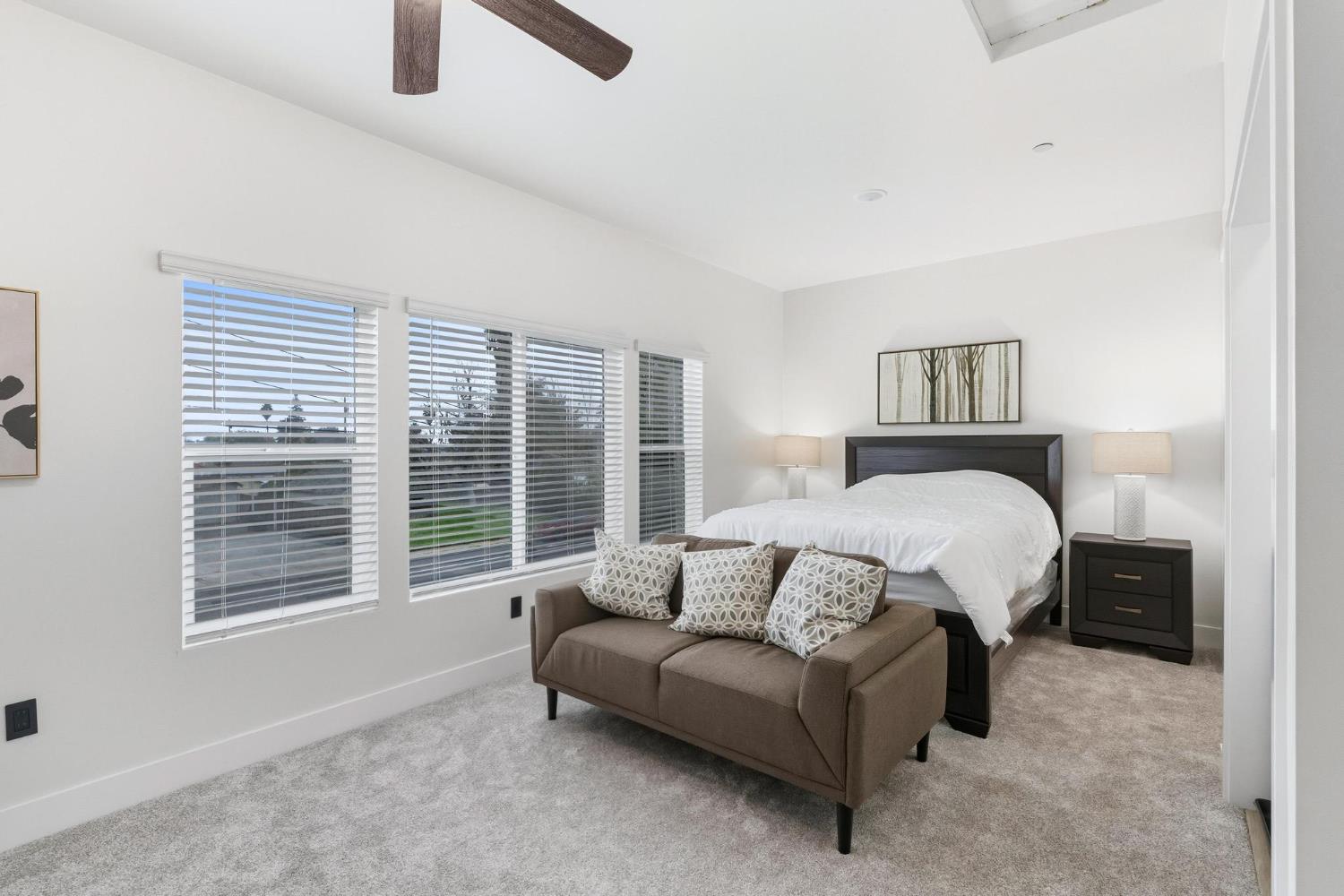 622 North Stockton Avenue Ripon, CA 95366 - Photo 4 of 34 a bedroom with a bed a couch and a window