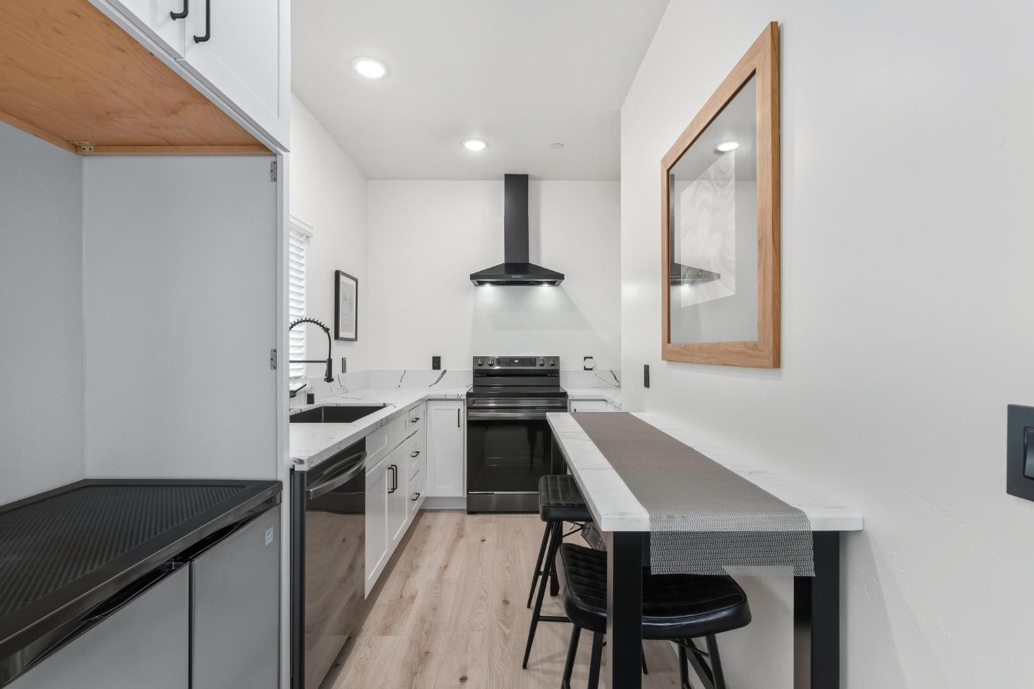 622 North Stockton Avenue Ripon, CA 95366 - Photo 5 of 34 a kitchen with a table chairs sink and stove