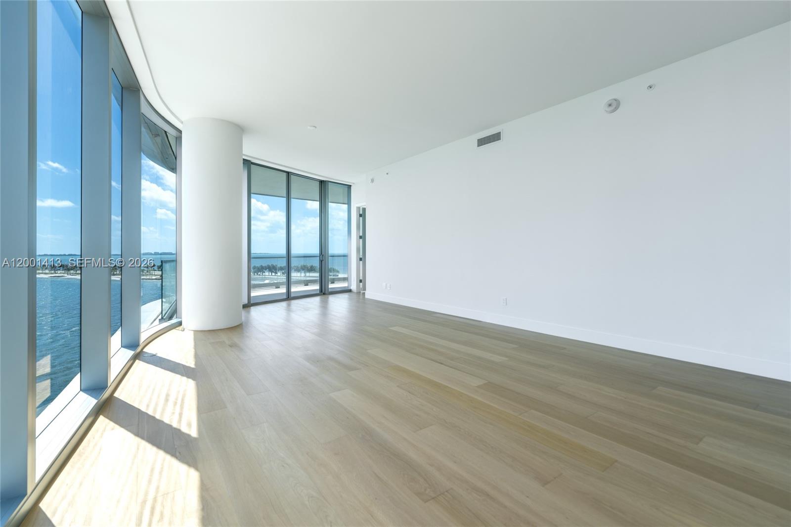 175 Southeast 25th Road, Unit 501 Miami, FL 33129 - Photo 12 of 67 a view of an empty room with wooden floor and a window