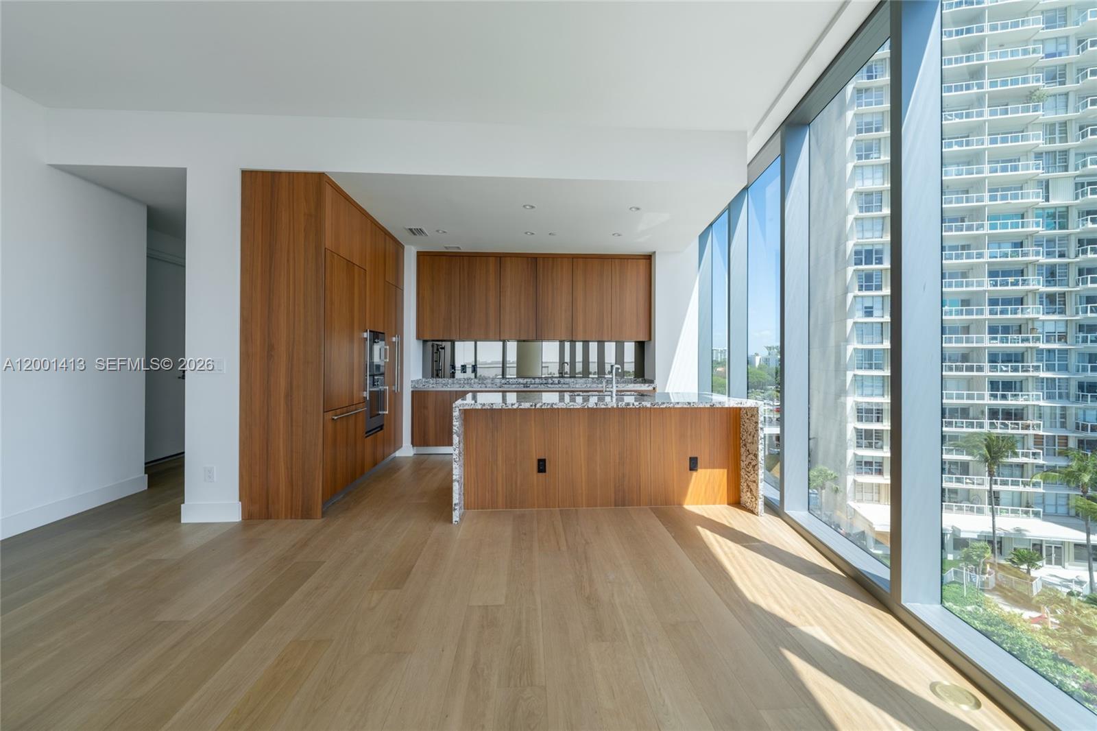 175 Southeast 25th Road, Unit 501 Miami, FL 33129 - Photo 15 of 67 a view of kitchen with stainless steel appliances granite countertop a refrigerator and a wooden floor