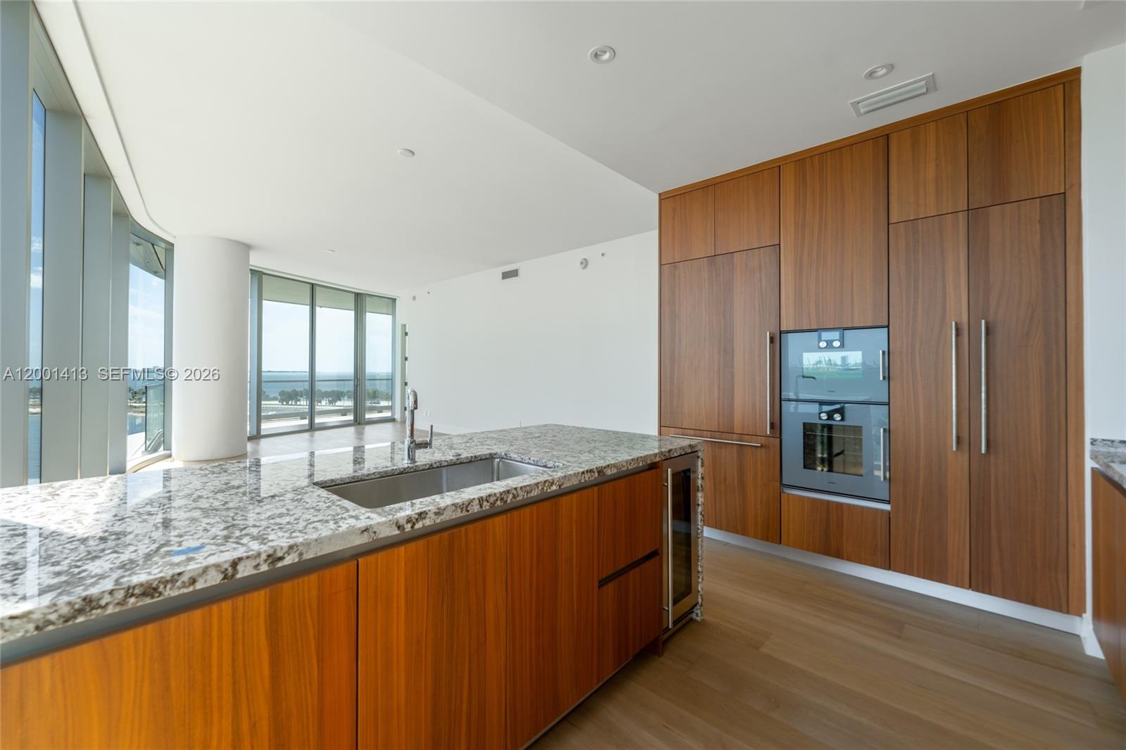 175 Southeast 25th Road, Unit 501 Miami, FL 33129 - Photo 18 of 67 a kitchen with granite countertop cabinets and wooden floor