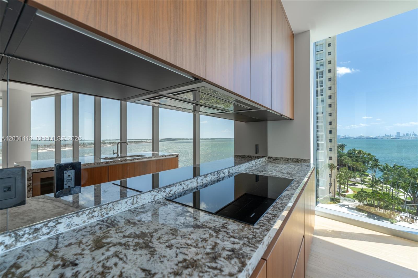 175 Southeast 25th Road, Unit 501 Miami, FL 33129 - Photo 19 of 67 a kitchen with stainless steel appliances granite countertop a sink and a large window