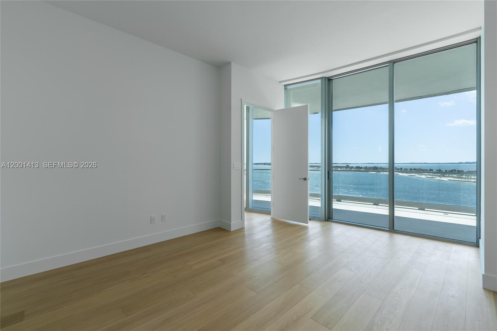 175 Southeast 25th Road, Unit 501 Miami, FL 33129 - Photo 20 of 67 a view of an empty room with wooden floor and a window