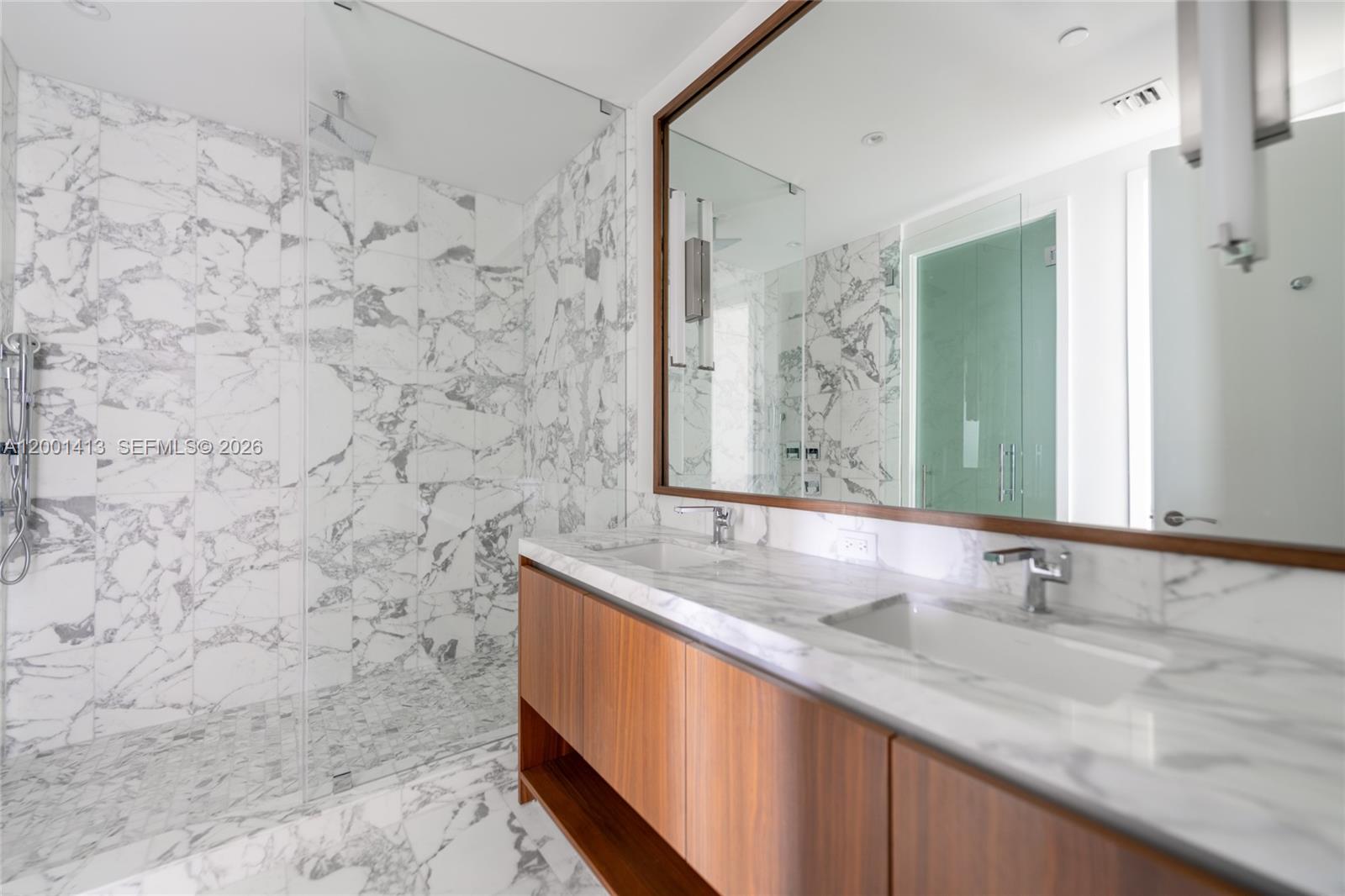 175 Southeast 25th Road, Unit 501 Miami, FL 33129 - Photo 26 of 67 a bathroom with a granite countertop sink and a mirror