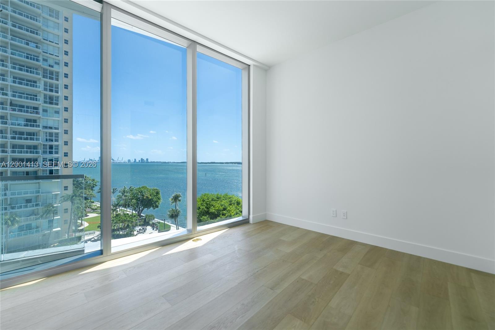 175 Southeast 25th Road, Unit 501 Miami, FL 33129 - Photo 28 of 67 an empty room with wooden floor and windows
