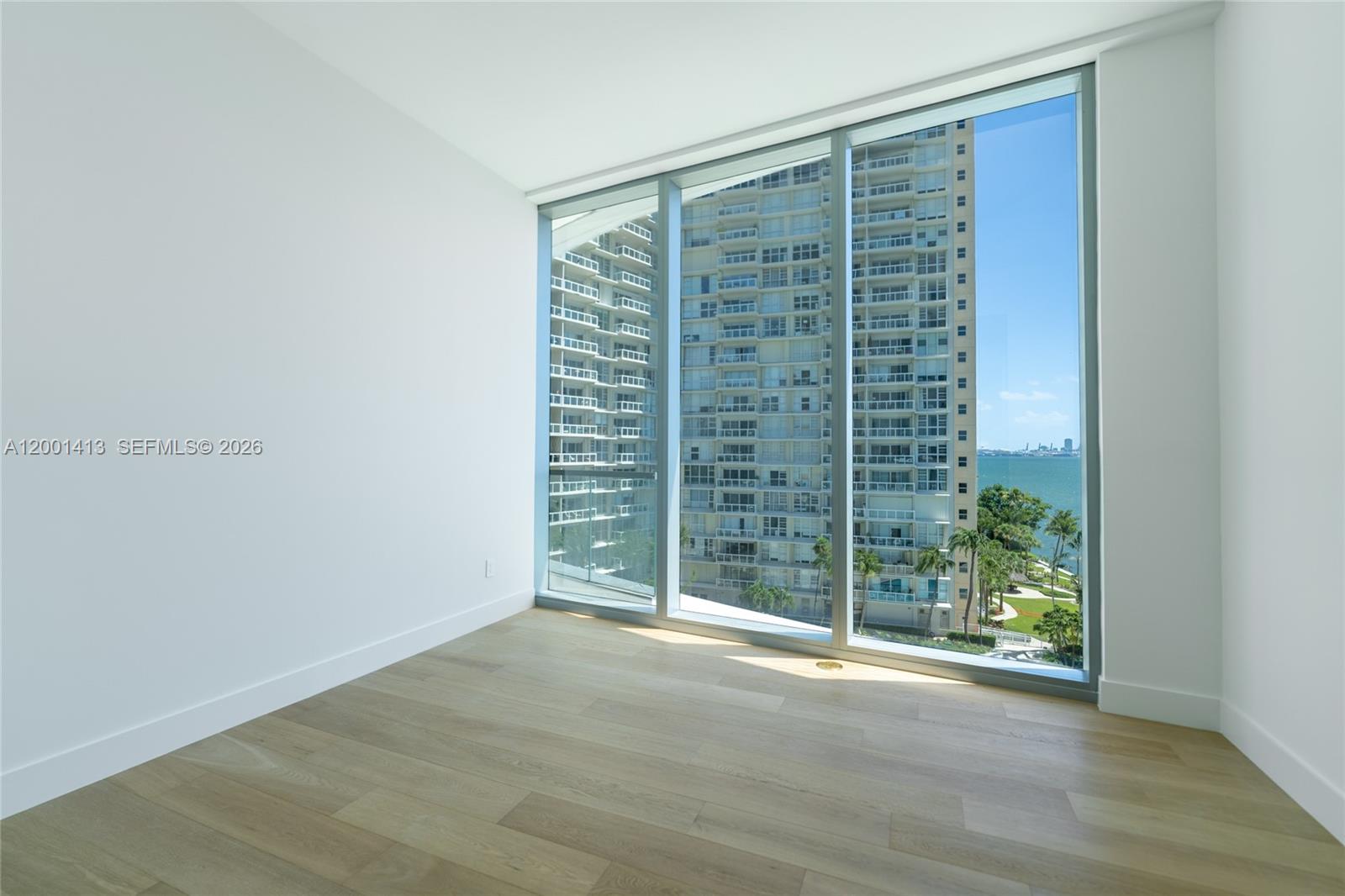 175 Southeast 25th Road, Unit 501 Miami, FL 33129 - Photo 30 of 67 a view of an empty room with wooden floor and a window