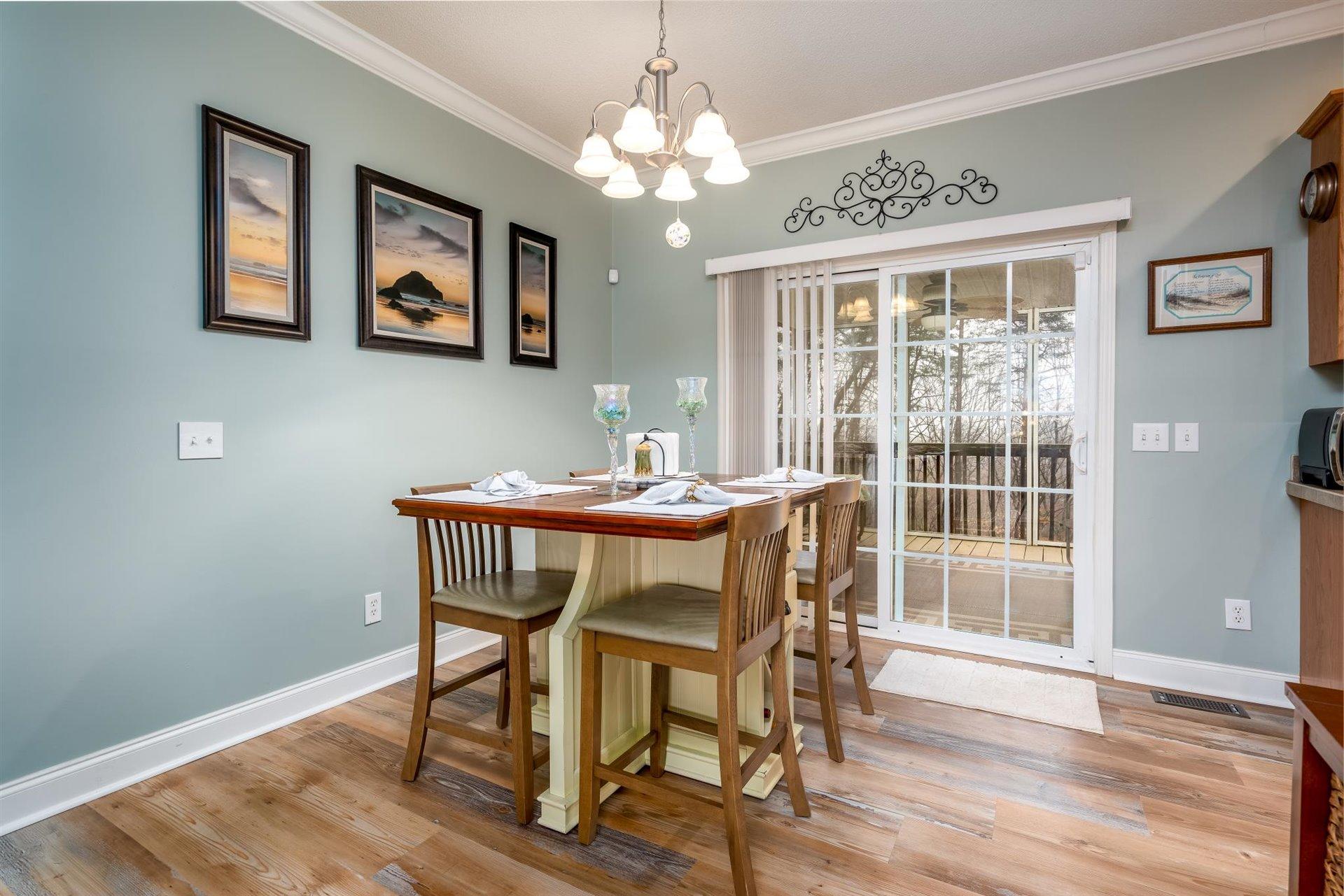 281 Sunny Field Road Wirtz, VA 24184 - Photo 13 of 44 a dining room with wooden floor and chandelier