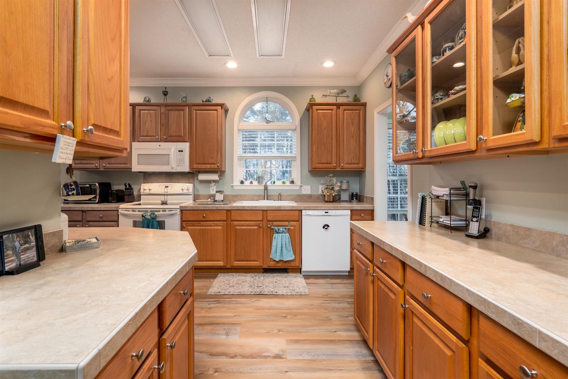 281 Sunny Field Road Wirtz, VA 24184 - Photo 19 of 44 a kitchen with a sink stove and cabinets