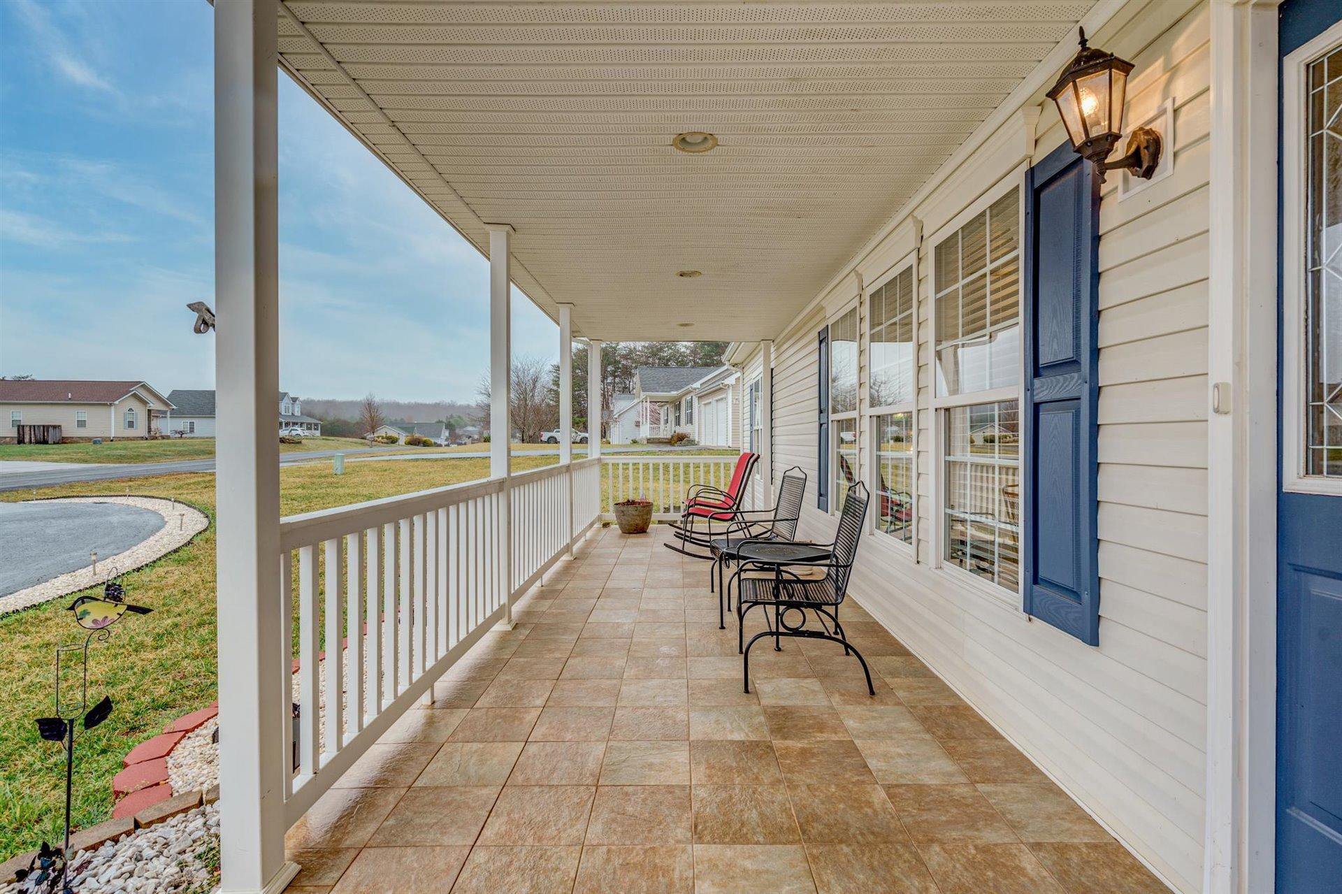 281 Sunny Field Road Wirtz, VA 24184 - Photo 6 of 44 a balcony with chairs and with potted plants