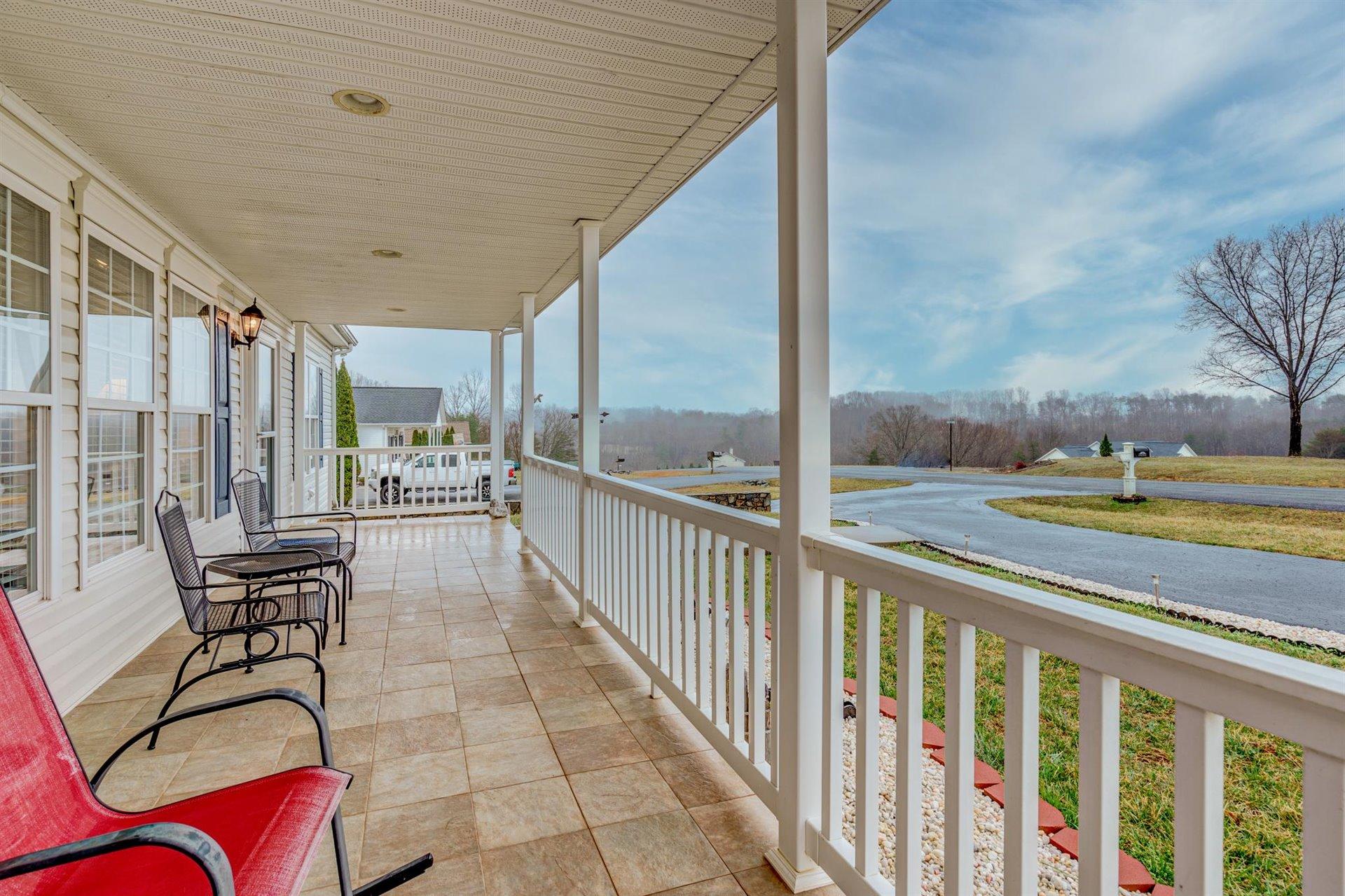 281 Sunny Field Road Wirtz, VA 24184 - Photo 7 of 44 a view of a chairs and tables in the balcony