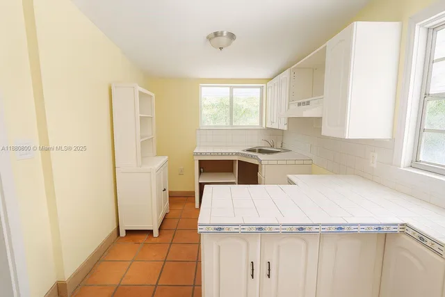 a view of a backyard with plants and outdoor seating