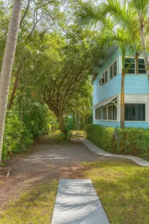 a front view of a house with a yard and trees
