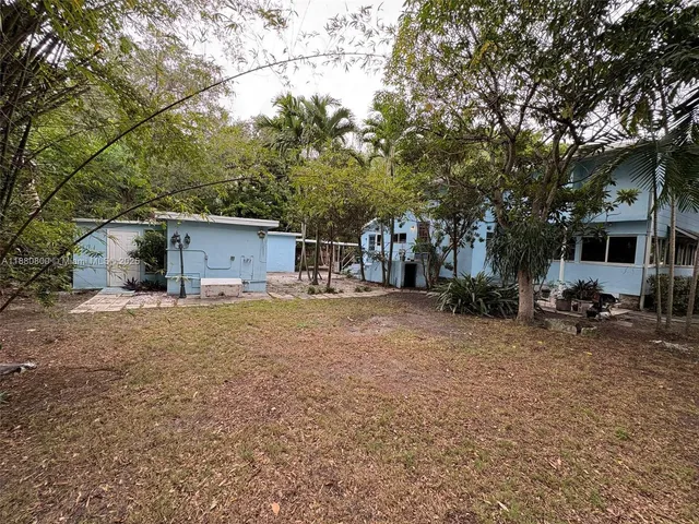a front view of house with yard and trees