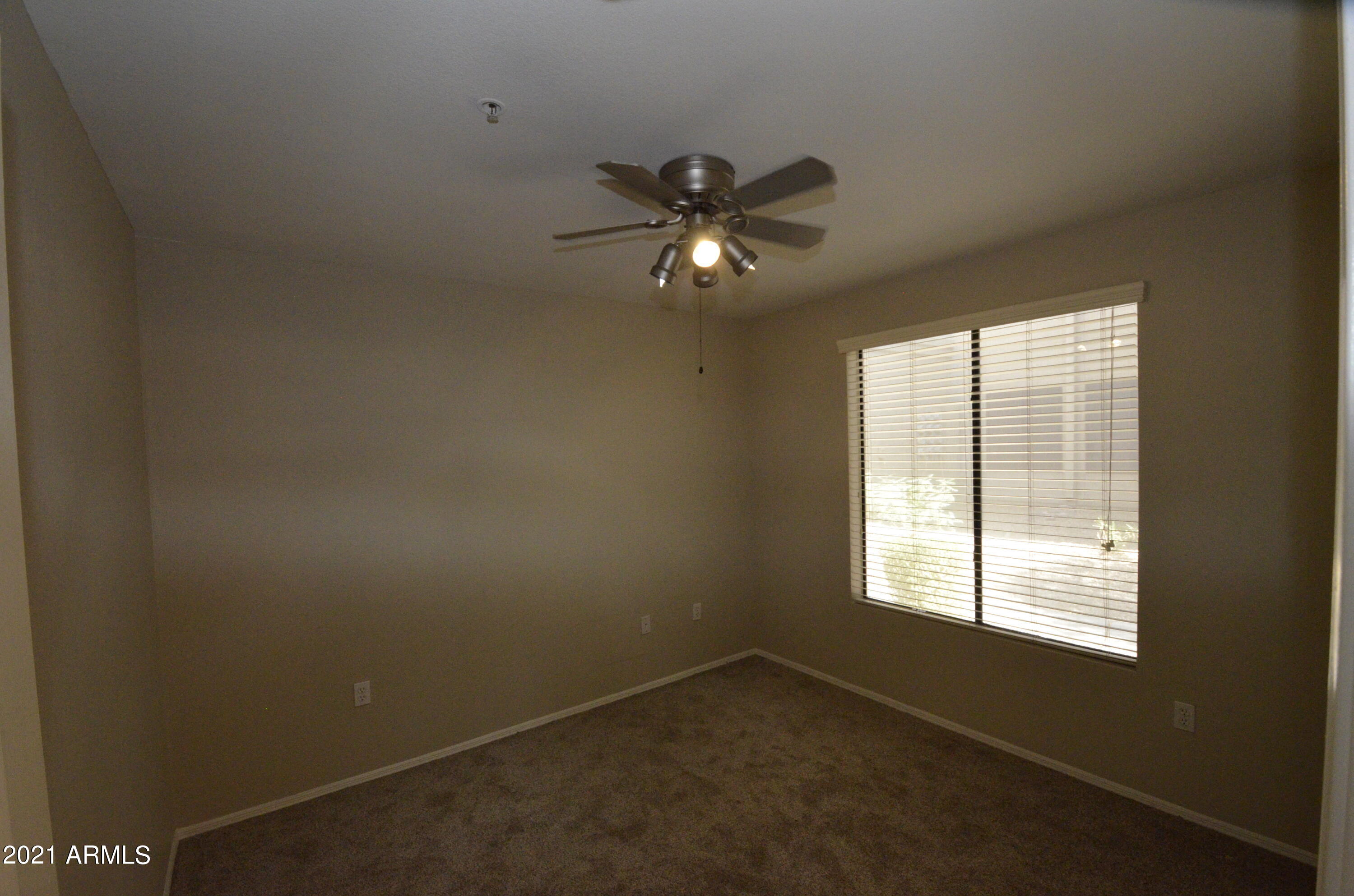 3848 North 3rd Avenue, Unit 1013 Phoenix, AZ 85013 - Photo 12 of 21 a view of a livingroom with a ceiling fan and window