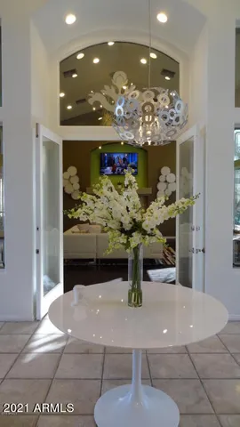 a view of a dining room with furniture and chandelier
