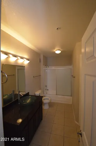 a bathroom with a sink a toilet and mirror