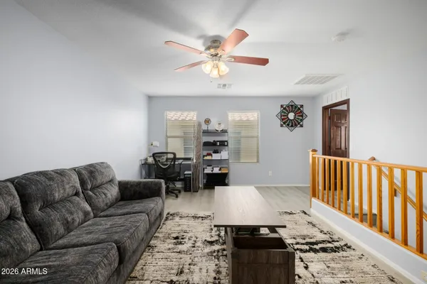 a living room with furniture fireplace and a window