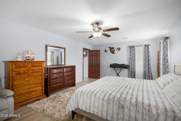 a bedroom with a bed and a dresser