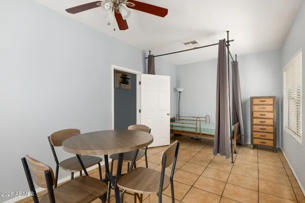 a dining room with furniture and window