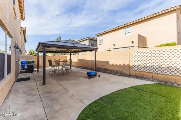a view of a backyard with sitting area