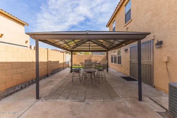 a view of a chairs and table in the patio