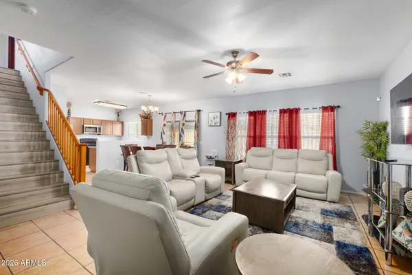 a living room with furniture a chandelier and a window