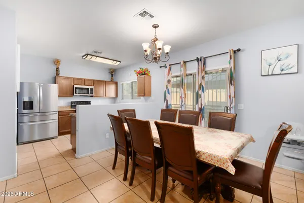 a view of a dining room with furniture and a chandelier