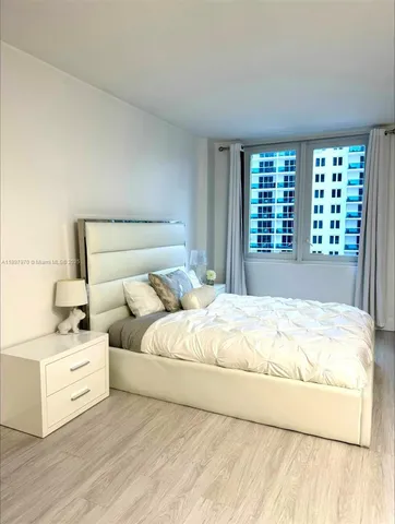 a large white bed in a white room