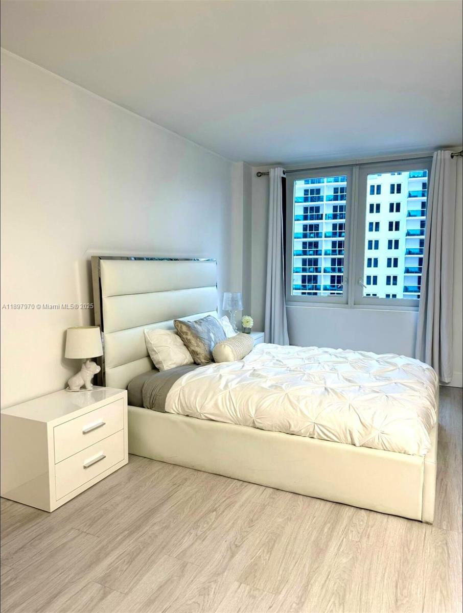 2301 Collins Avenue, Unit 619 Miami Beach, FL 33139 - Photo 7 of 16 a large white bed in a white room