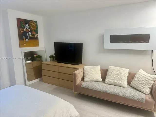 a bedroom with a bed and a couch