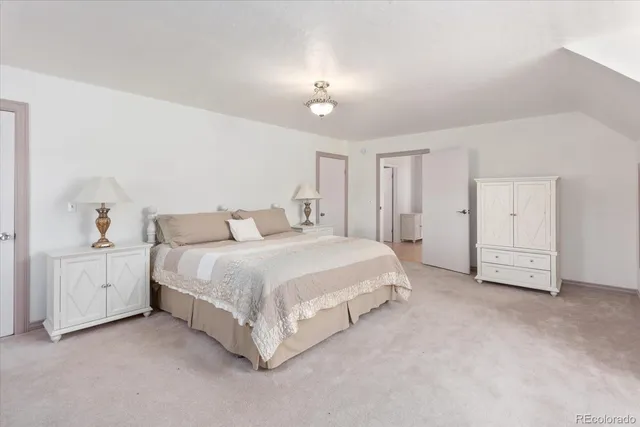 a living room with furniture and a dining table with wooden floor