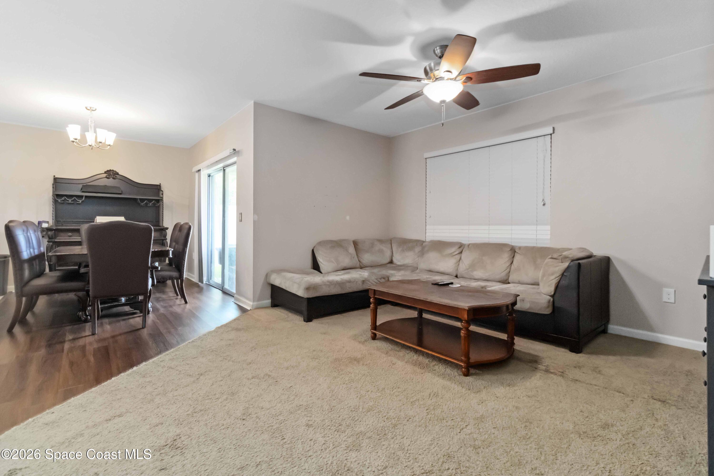 1070 Swiss Pointe Lane Rockledge, FL 32955 - Photo 11 of 24 a living room with furniture and a ceiling fan