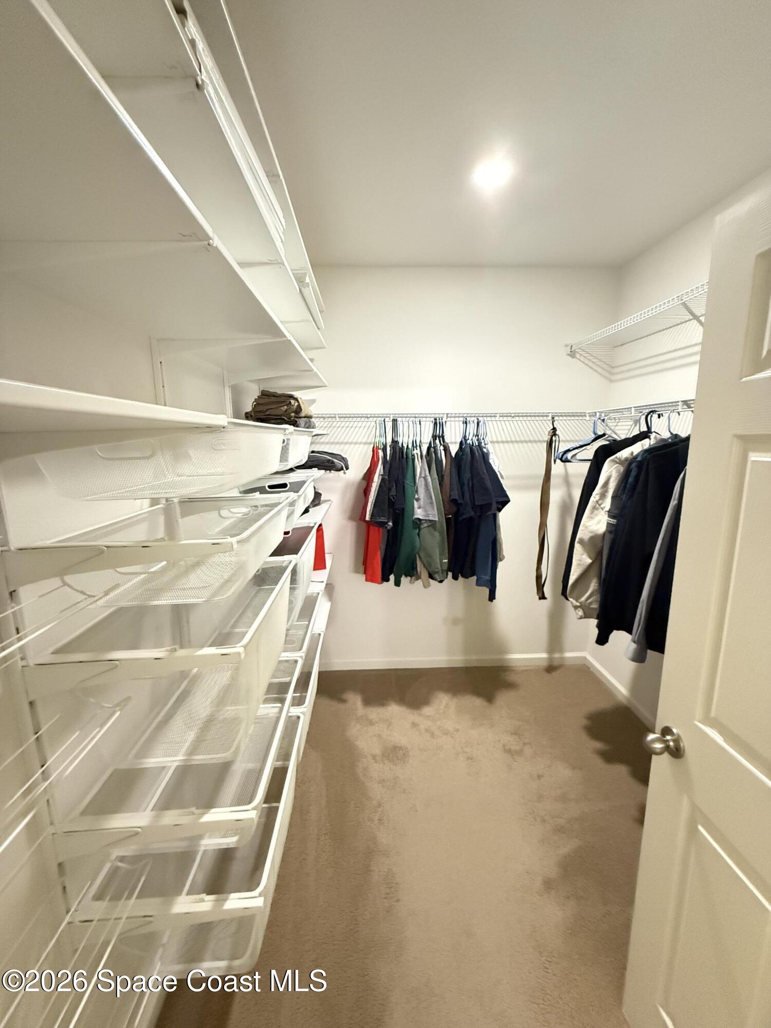 1070 Swiss Pointe Lane Rockledge, FL 32955 - Photo 13 of 24 a view of walk in closet with clothes and shoes
