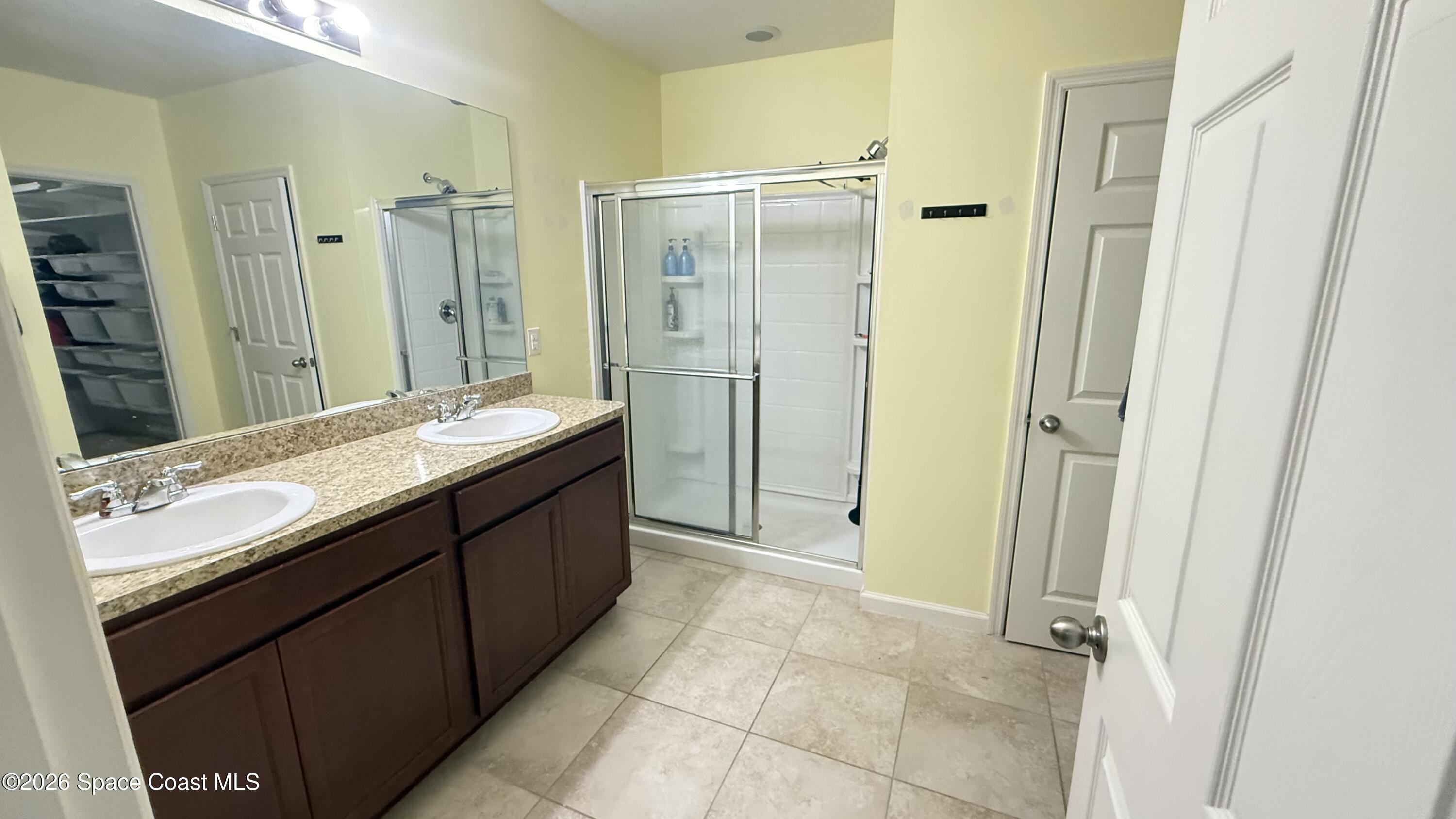 1070 Swiss Pointe Lane Rockledge, FL 32955 - Photo 17 of 24 a bathroom with a double vanity sink mirror double and shower