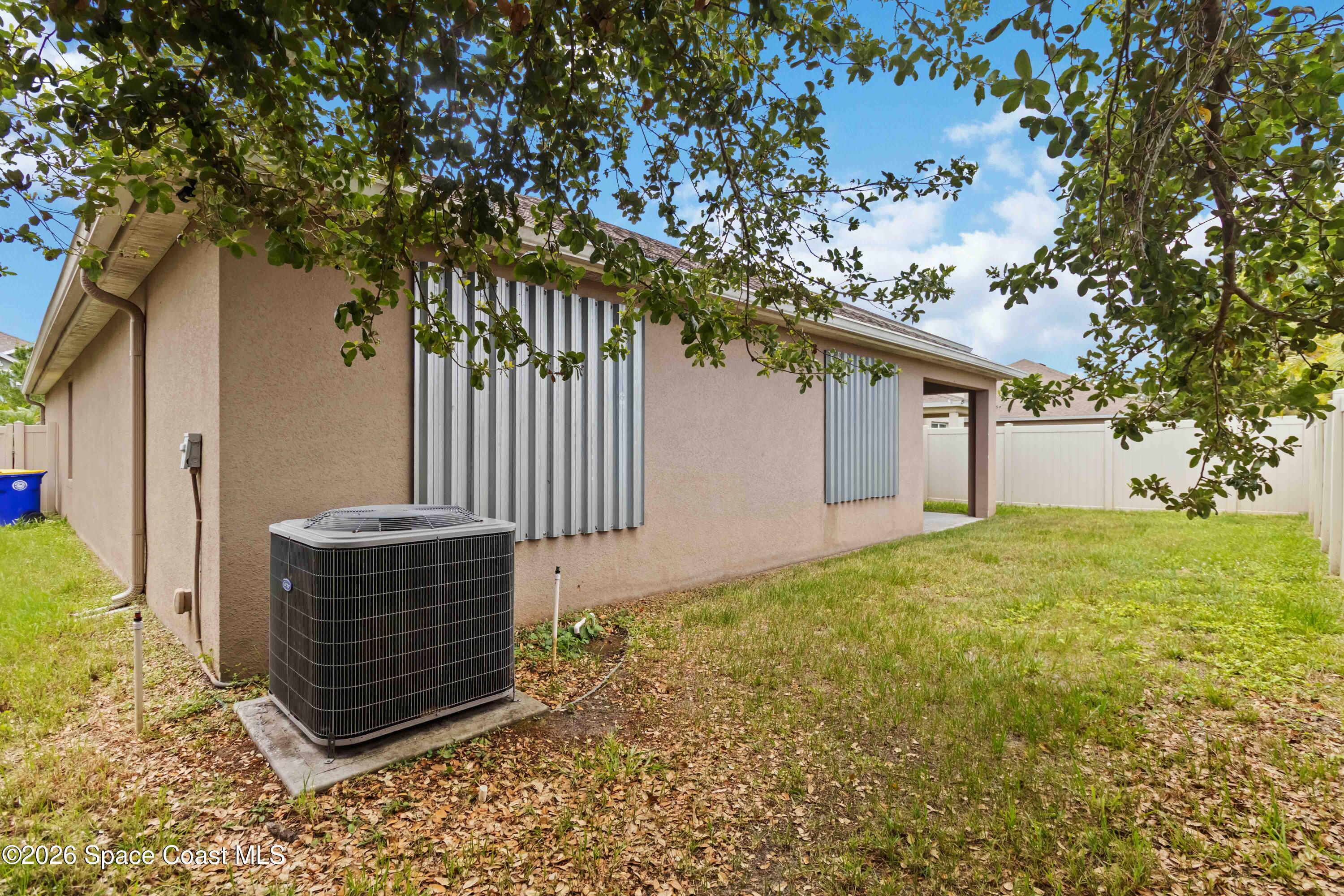 1070 Swiss Pointe Lane Rockledge, FL 32955 - Photo 22 of 24 a backyard of a house with lots of green space
