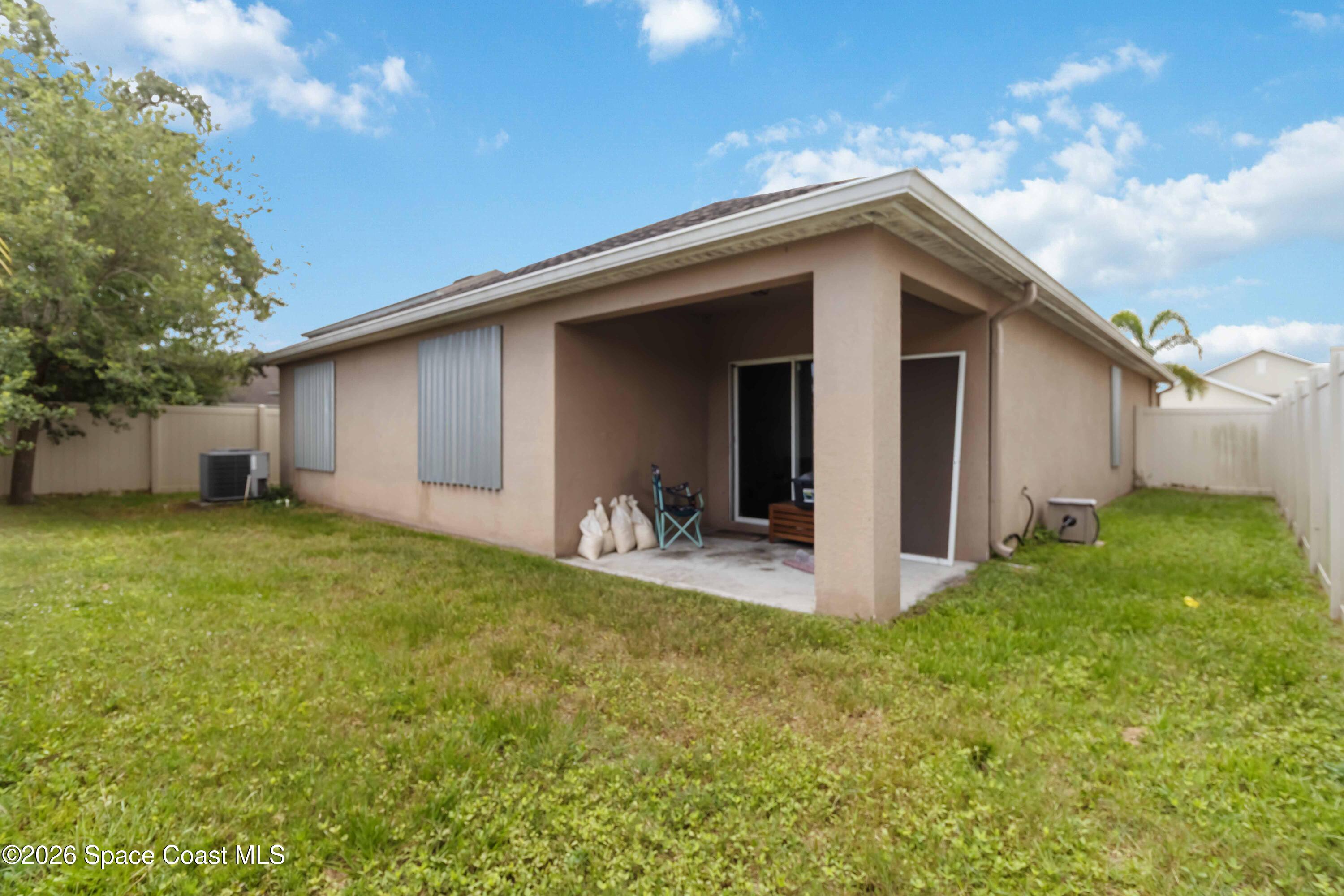 1070 Swiss Pointe Lane Rockledge, FL 32955 - Photo 23 of 24 a view of a backyard with garage and outdoor seating