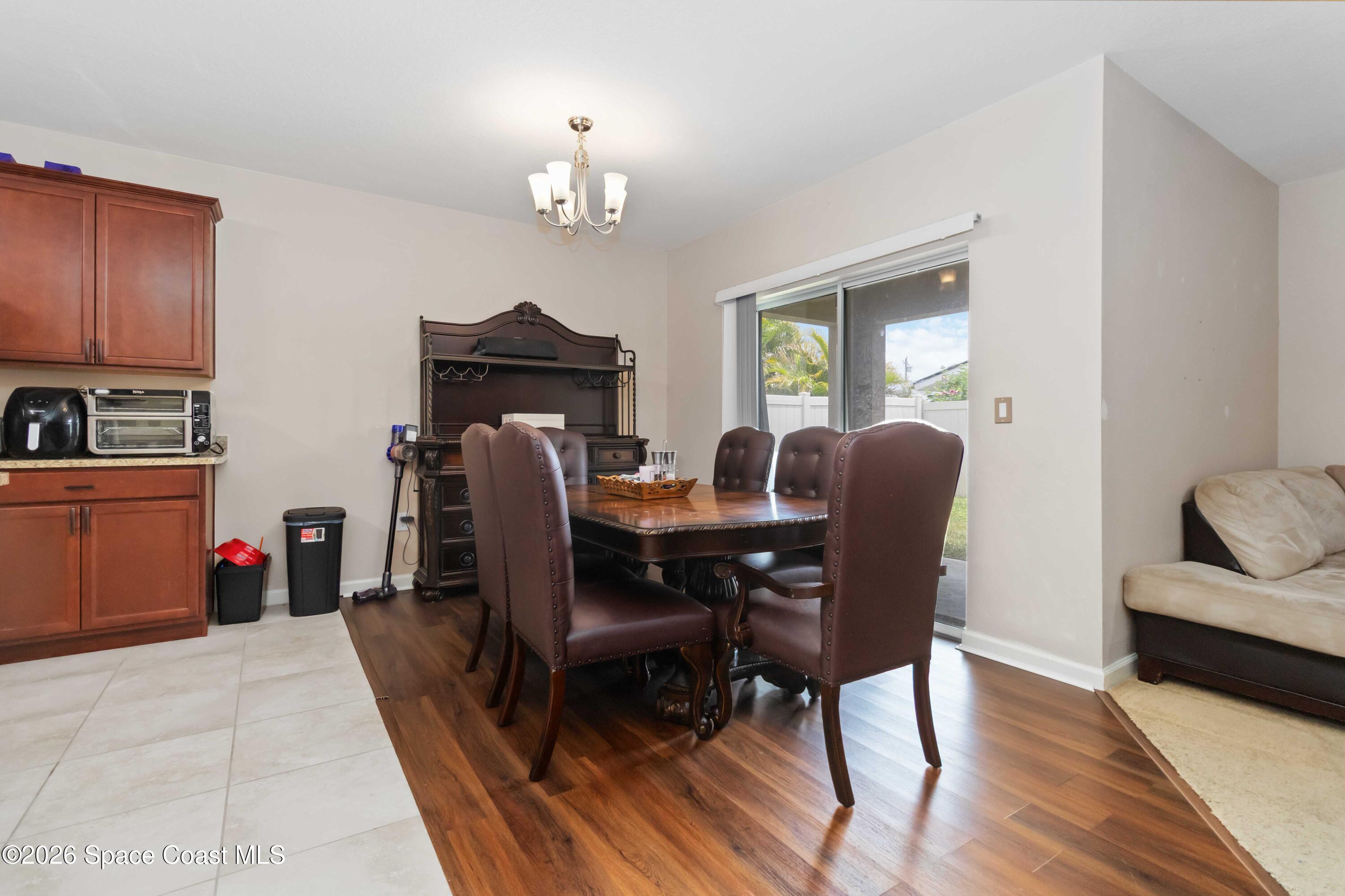 1070 Swiss Pointe Lane Rockledge, FL 32955 - Photo 6 of 24 a view of a dining room with furniture and wooden floor