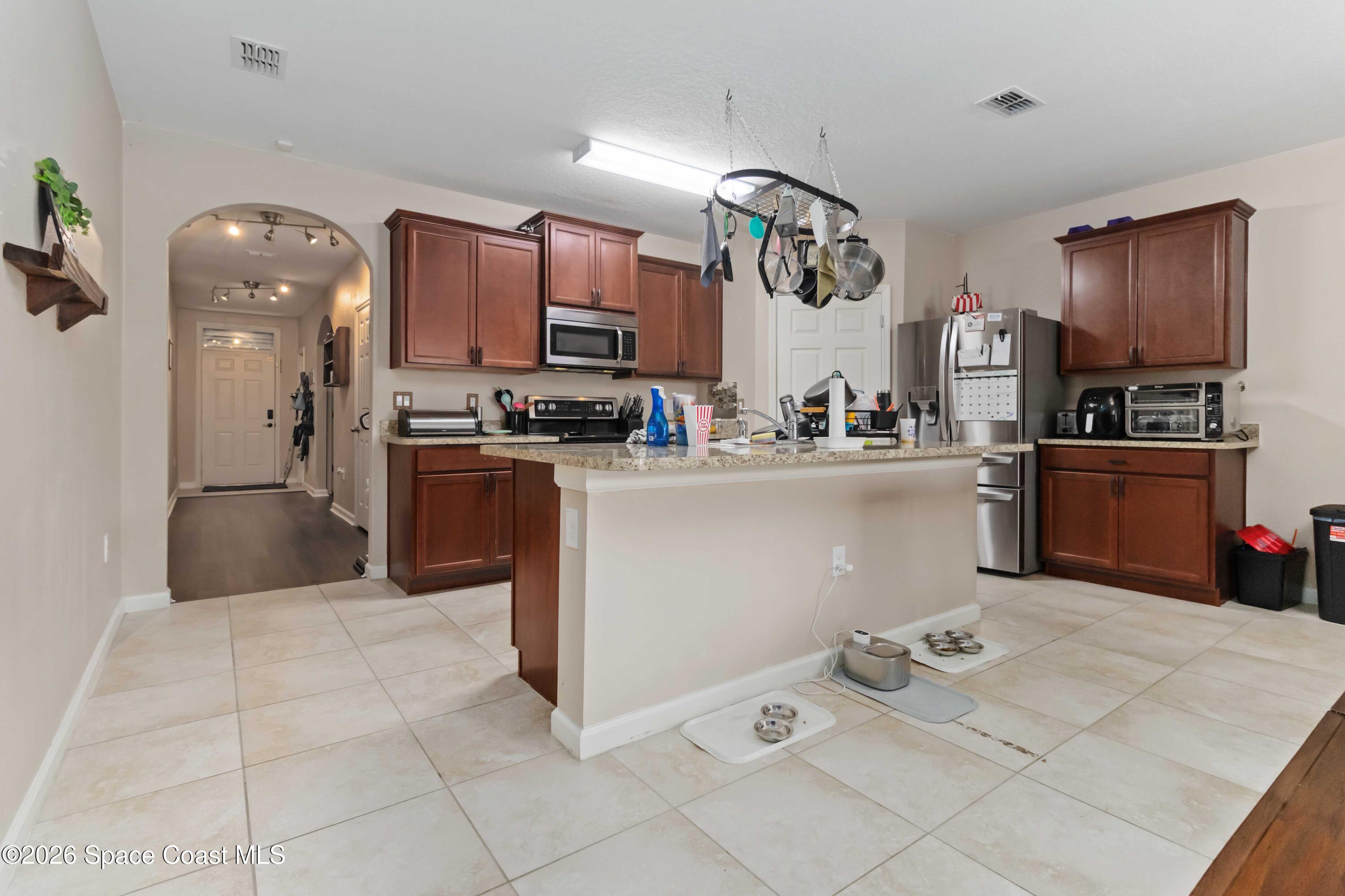 1070 Swiss Pointe Lane Rockledge, FL 32955 - Photo 7 of 24 a kitchen with stainless steel appliances granite countertop a sink dishwasher stove top oven and cabinets