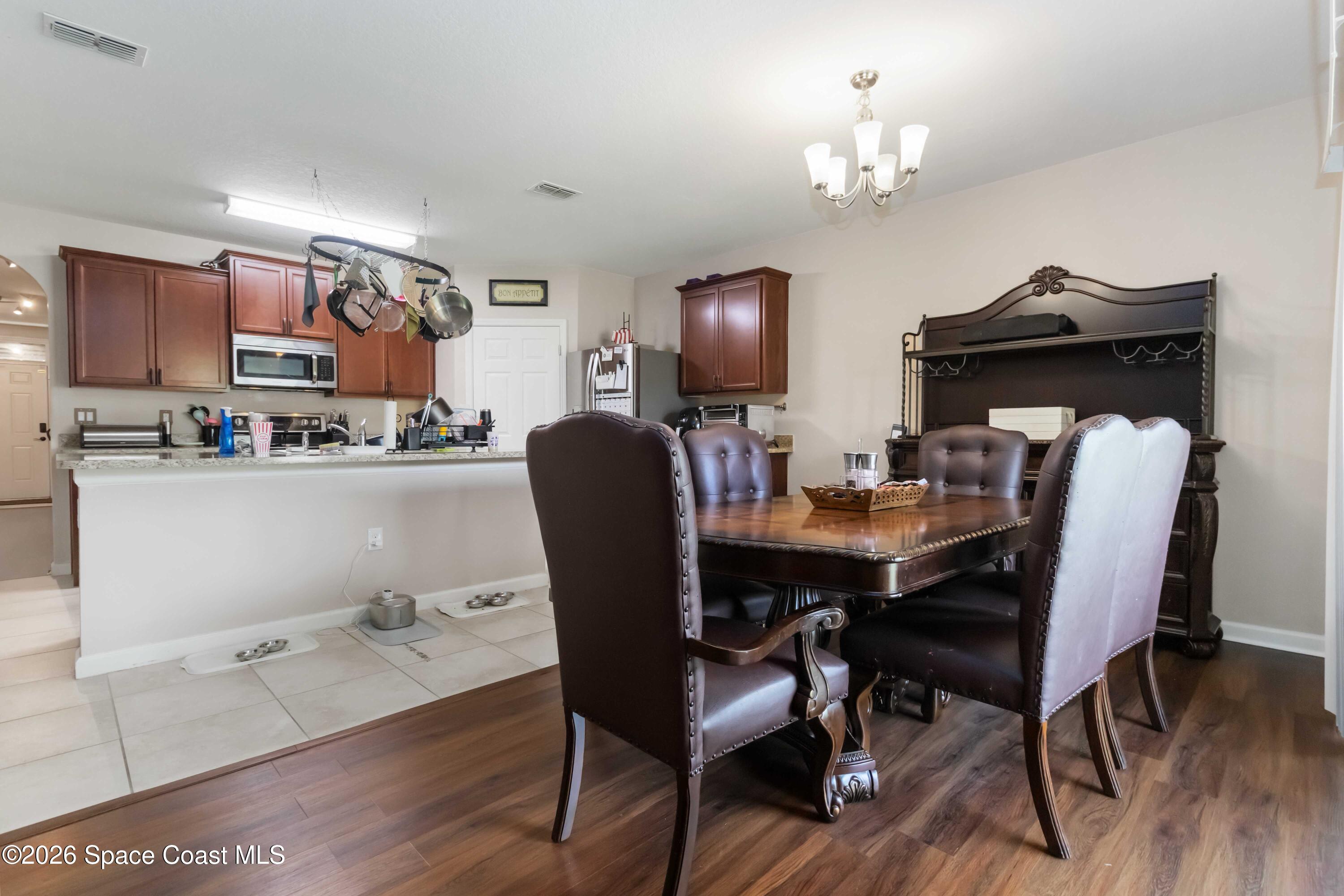 1070 Swiss Pointe Lane Rockledge, FL 32955 - Photo 8 of 24 a dining room with furniture and wooden floor