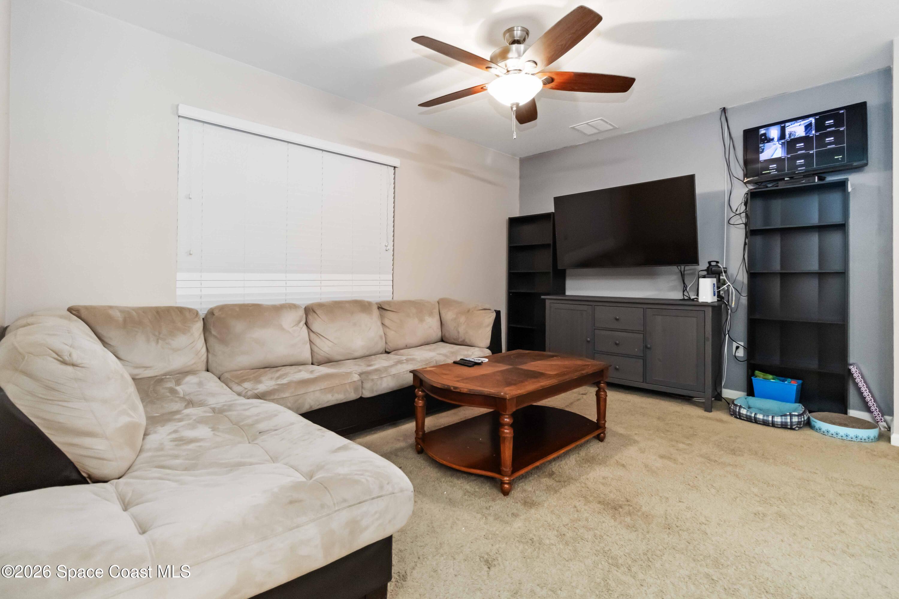 1070 Swiss Pointe Lane Rockledge, FL 32955 - Photo 9 of 24 a living room with furniture and a flat screen tv