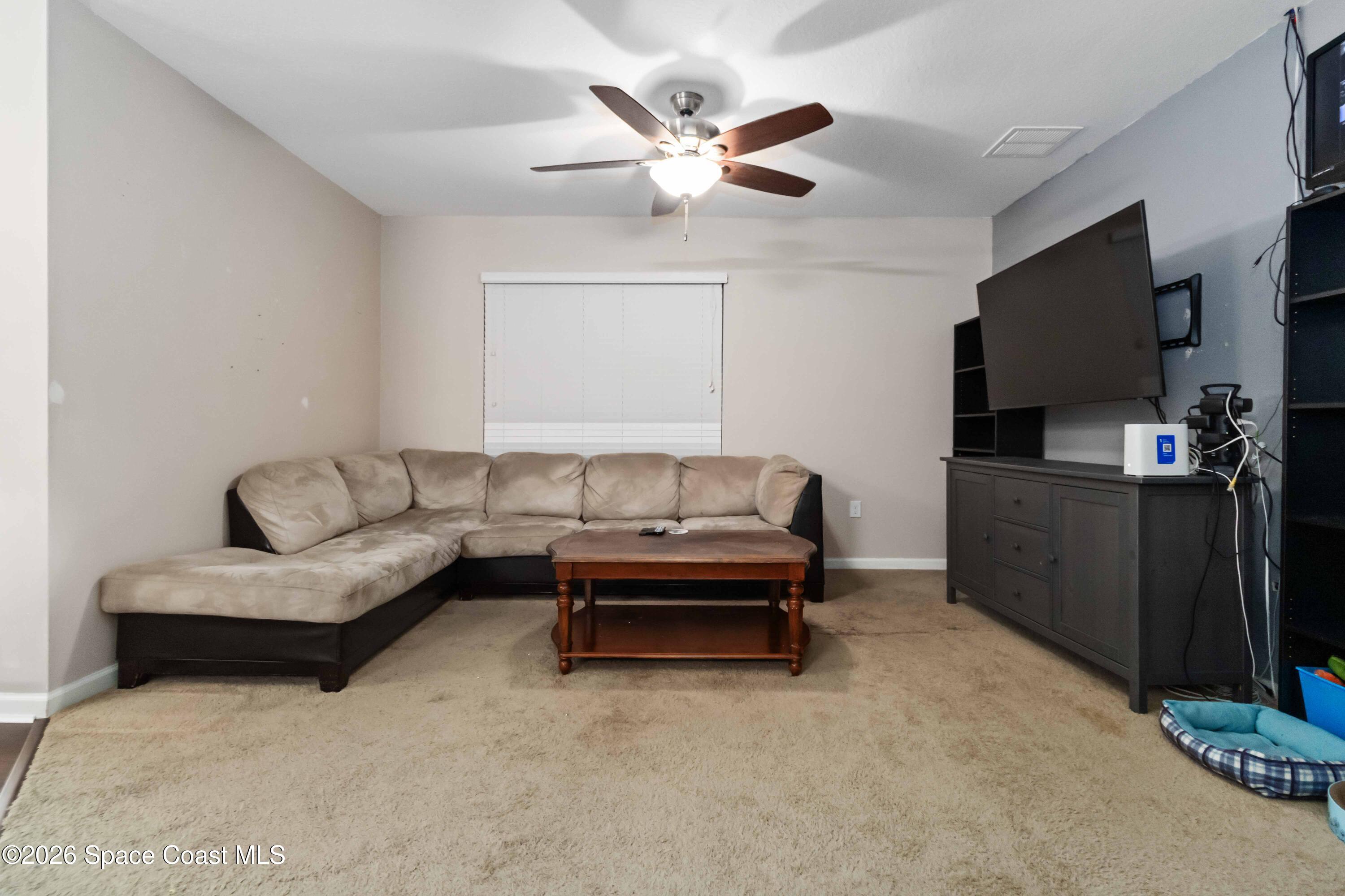 1070 Swiss Pointe Lane Rockledge, FL 32955 - Photo 10 of 24 a living room with furniture and a flat screen tv