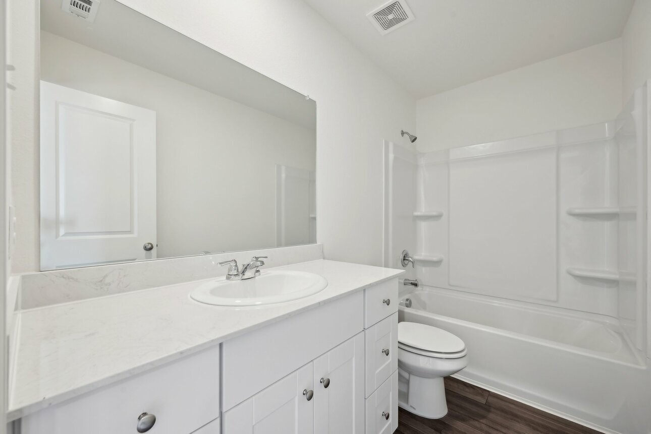 9373 Beryl Lane Conroe, TX 77303 - Photo 6 of 6 a bathroom with a sink a toilet and shower