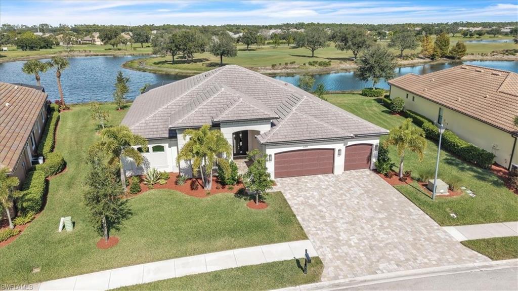 an aerial view of a house with garden space and lake view