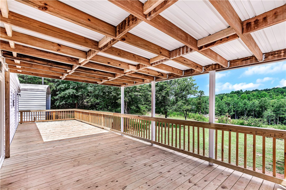 403 Hancox Place Westminster, SC 29693 - Photo 19 of 39 A deep covered porch provides a serene outdoor living space with scenic tree-lined views.